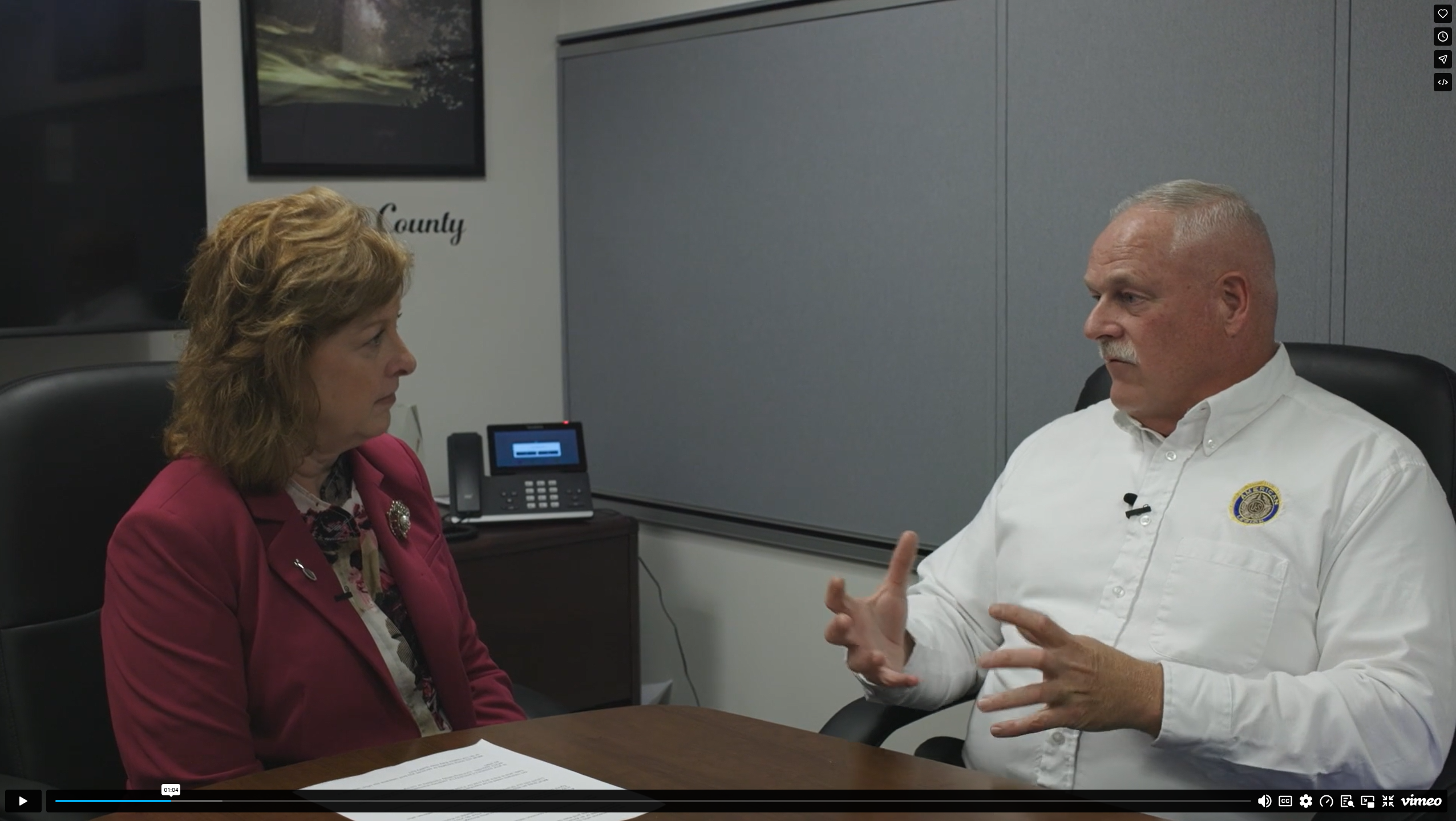Senator Culver sitting with Bill McGovern in an office setting and having a conversation.